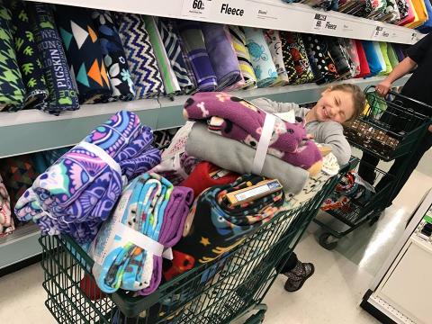 Emma with blankets at store